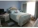 Comfortable bedroom with blue walls, large window, and a decorative bedframe at 4245 Toccopola St, Raleigh, NC 27604