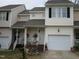 Two-story townhome boasts a one-car garage and a cozy front porch with white railings and steps at 4245 Toccopola St, Raleigh, NC 27604