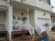 Inviting front porch with flowers, stairs, and white railings, adding to curb appeal at 4245 Toccopola St, Raleigh, NC 27604