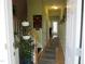 Inviting entry hallway featuring hardwood floors, a staircase, and charming decor at 4245 Toccopola St, Raleigh, NC 27604