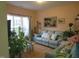 Bright living room with a comfortable sofa, large window, and tasteful decorations at 4245 Toccopola St, Raleigh, NC 27604