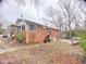 Exterior view of the home's back featuring a combination of brick and siding at 4308 Old Chapel Hill Rd Rd, Durham, NC 27707