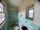 Small bathroom with green tile and peeling wallpaper at 4308 Old Chapel Hill Rd Rd, Durham, NC 27707