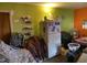 Messy bedroom with a fridge and a green wall at 4308 Old Chapel Hill Rd Rd, Durham, NC 27707