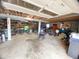 View of the cluttered garage providing ample space for parking and storage at 4308 Old Chapel Hill Rd Rd, Durham, NC 27707