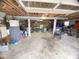 View of the cluttered garage providing ample space for parking and storage at 4308 Old Chapel Hill Rd Rd, Durham, NC 27707