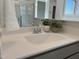 Bathroom vanity with a white countertop, grey cabinets, modern faucet, decor, and framed mirror at 46 Shortstop Cir, Four Oaks, NC 27524