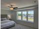 Bright bedroom with a ceiling fan, large windows, and neutral decor at 46 Shortstop Cir, Four Oaks, NC 27524