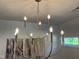 Stylish chandelier with curved arms, adding elegance to the room's ambiance at 46 Shortstop Cir, Four Oaks, NC 27524