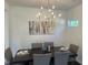 Dining room with a dark wood table, gray chairs, and a modern chandelier at 46 Shortstop Cir, Four Oaks, NC 27524