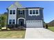 Charming two-story home with a stone facade, white trim, and a two-car garage at 46 Shortstop Cir, Four Oaks, NC 27524