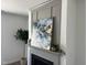 Elegant gray fireplace with a decorative mantel and modern artwork at 46 Shortstop Cir, Four Oaks, NC 27524