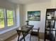 Bright office space with a large window, rustic desk, and stylish decor at 46 Shortstop Cir, Four Oaks, NC 27524
