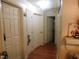 Hallway features multiple white doors and wood-look flooring at 468 Dickens Dr, Raleigh, NC 27610