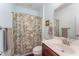 Bathroom with an decorative floral shower curtain, light blue walls and a sink at 580 Long View Dr, Youngsville, NC 27596