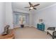 Bedroom with natural light, ceiling fan, neutral carpet and blue accents in the curtains and furniture at 580 Long View Dr, Youngsville, NC 27596