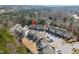 Aerial view of townhomes in a wooded area, with ample parking and green spaces at 6233 Pesta Ct, Raleigh, NC 27612