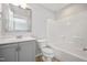 Bright bathroom with a single vanity with gray cabinets, a large mirror, and a tub-shower combo at 6233 Pesta Ct, Raleigh, NC 27612