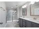 Modern bathroom featuring a double vanity with quartz countertops and a glass-enclosed shower at 6233 Pesta Ct, Raleigh, NC 27612