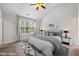 Cozy bedroom features neutral decor, a ceiling fan, and a large window for natural light at 6233 Pesta Ct, Raleigh, NC 27612