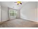 Bedroom with vaulted ceiling, ceiling fan, large window, and neutral walls at 6233 Pesta Ct, Raleigh, NC 27612