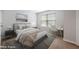 Comfortable bedroom with a gray bed, modern desk, and soft natural light at 6233 Pesta Ct, Raleigh, NC 27612