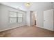 Bright bedroom featuring plush carpeting and a large window for natural lighting at 6233 Pesta Ct, Raleigh, NC 27612