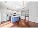 Open concept kitchen features an island with a blue base, stainless appliances, and white cabinets at 6233 Pesta Ct, Raleigh, NC 27612