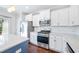 Well-lit kitchen with stainless steel appliances, ample cabinet space, and a large island at 6233 Pesta Ct, Raleigh, NC 27612