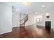 Open-concept living room showcases hardwood floors, a fireplace, and a staircase at 6233 Pesta Ct, Raleigh, NC 27612