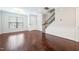 Bright living room with hardwood floors, neutral walls, and staircase with decorative wrought iron balusters at 6233 Pesta Ct, Raleigh, NC 27612