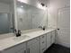 Bathroom features dual sinks with black faucets and a large, well-lit mirror at 704 Compeer Way # 28, Rolesville, NC 27571