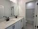 Elegant bathroom featuring double sinks, granite countertops, and sleek black hardware at 704 Compeer Way # 28, Rolesville, NC 27571