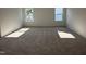 Spacious bedroom with plush neutral carpeting and natural light from two windows at 704 Compeer Way # 28, Rolesville, NC 27571
