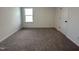 Comfortable bedroom featuring plush carpet and a window providing natural light at 704 Compeer Way # 28, Rolesville, NC 27571