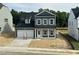 Two story home featuring blue siding, white trim, black roof, and an attached two car garage at 704 Compeer Way # 28, Rolesville, NC 27571