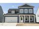 Exterior of a two-story home with blue siding, white trim, shutters, and a two-car garage at 704 Compeer Way # 28, Rolesville, NC 27571