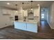 Spacious kitchen with white cabinets, quartz countertops and stainless steel appliances at 704 Compeer Way # 28, Rolesville, NC 27571