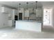 Spacious kitchen with white cabinets, stainless steel appliances and an island at 704 Compeer Way # 28, Rolesville, NC 27571