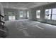 Bright, unfinished living room with access to a deck, and large windows at 704 Compeer Way # 28, Rolesville, NC 27571