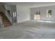 Living room with staircase and sliding glass door leading to the backyard at 704 Compeer Way # 28, Rolesville, NC 27571