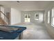 Bright living room featuring sliding glass doors, large windows, and a stairway at 704 Compeer Way # 28, Rolesville, NC 27571