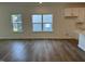 Open living space with hardwood floors, large windows offering plenty of natural light, and kitchen views at 704 Compeer Way # 28, Rolesville, NC 27571