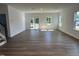 A spacious room with great natural lighting, hardwood floors, large windows and staircase view at 704 Compeer Way # 28, Rolesville, NC 27571