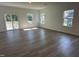 Spacious room featuring beautiful floors, natural light from three windows, and a sliding glass door at 704 Compeer Way # 28, Rolesville, NC 27571
