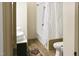 Bright bathroom with double sinks, modern vanity, and shower with decorative curtain at 735 Alexander Ave, Henderson, NC 27536