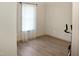 This bedroom has wood-look floors and a window with bright natural light at 735 Alexander Ave, Henderson, NC 27536