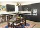 Modern kitchen with sleek dark cabinetry, stainless steel appliances, and decorative chandelier at 735 Alexander Ave, Henderson, NC 27536