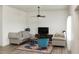 Cozy living room with comfortable seating, a modern ceiling fan, and decorative rug at 735 Alexander Ave, Henderson, NC 27536