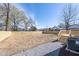 Spacious backyard features a wood fence, wooden deck with stairs, and gravel walkway around HVAC unit at 818 E Holly St, Rocky Mount, NC 27801